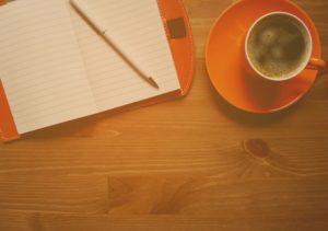 orange coffee cup on desk