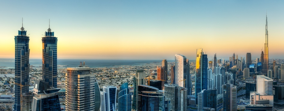 Panoramic view of Dubai's business bay with modern skyscrapers.