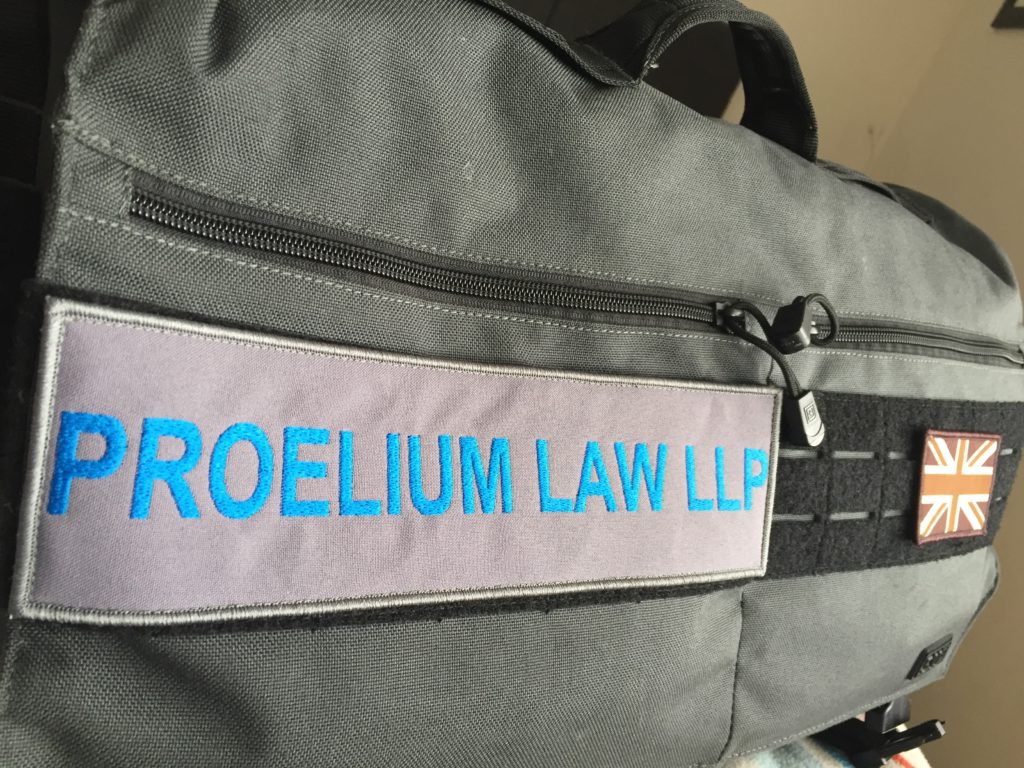 Proelium Law LLP badge on travel bag