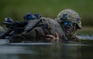 Royal Regiment of Artillery during a two-week long exercise in the UK. He is shown undergoing a two man Bergen river crossing drill.